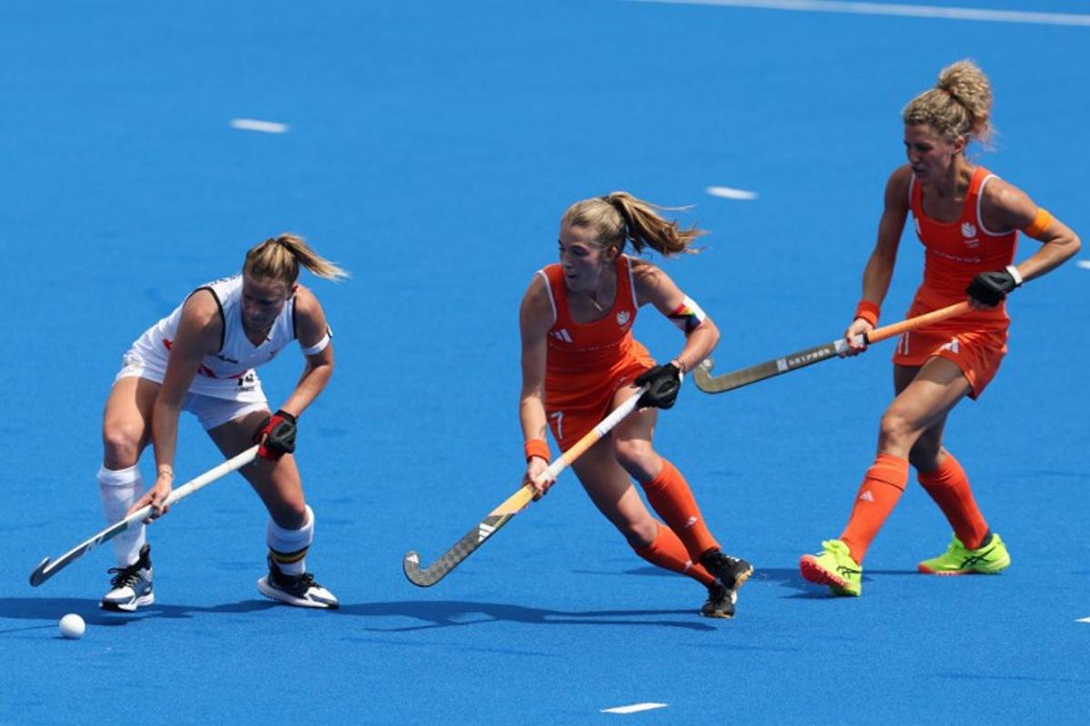 Belgium's midfielder #40 Camille Belis is marked by Netherlands' midfielder #07 Xan De Waard in the women's pool A field hockey match between Belgium and the Netherlands during the Paris 2024 Olympic Games at the Yves-du-Manoir Stadium in Colombes on August 2, 2024. Ahmad GHARABLI / AFP