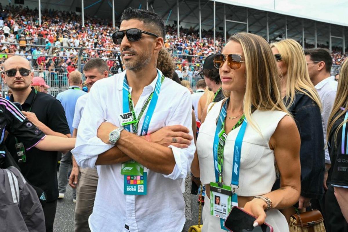 Inter Miami football player Uruguayan Luis Suarez and his wife Sofia Balbi tour the grid before the start of 2026 Miami Formula One Grand Prix at Miami International Autodrome in Miami Gardens, Florida, on May 3, 2026. CHANDAN KHANNA / AFP
