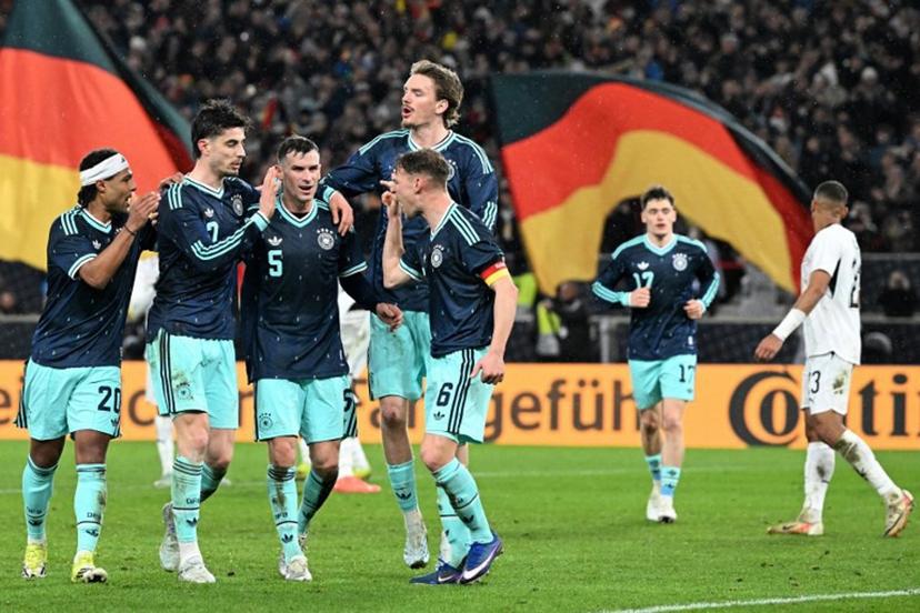 (From L) Germany's midfielder #20 Serge Gnabry, Germany's forward #07 Kai Havertz, Germany's midfielder #05 Pascal Gross, Germany's forward #11 Nick Woltemade and Germany's defender #06 Joshua Kimmich celebrate their team's first goal scored by Havertz during the international friendly football match between Germany and Ghana in Stuttgart, southwestern Germany on March 30, 2026. THOMAS KIENZLE / AFP
