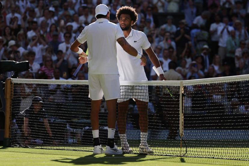 Italy's Matteo Berrettini is congratulated by France's Arthur Fils for winning their men's singles second round tennis match on the fourth day of the 2026 Wimbledon Championships at The All England Lawn Tennis and Croquet Club in Wimbledon, southwest London, on July 2, 2026. Adrian Dennis / AFP