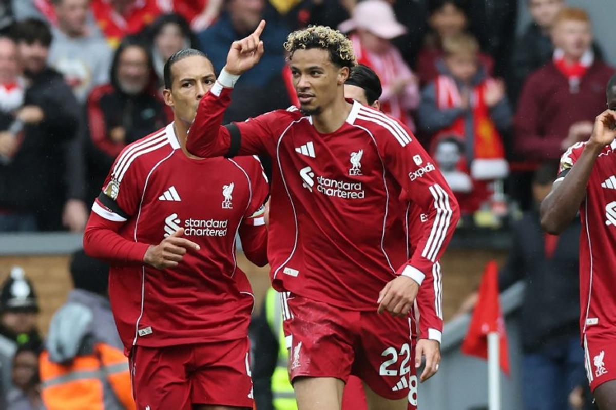 Liverpool's French striker #22 Hugo Ekitike (C) celebrates after scoring their second goal during the English Premier League football match between Liverpool and Everton at Anfield in Liverpool, north west England on September 20, 2025. Darren Staples / AFP