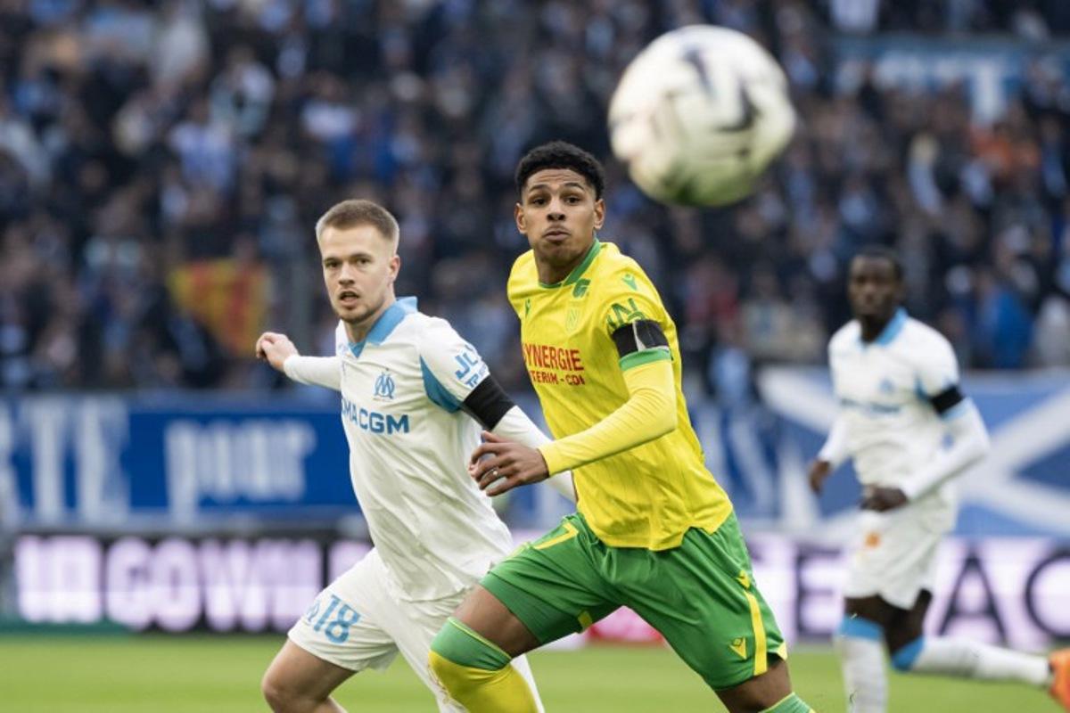 Nantes' French midfielder #17 Dehmaine Tabibou (R) and Marseille's Belgian midfielder #18 Arthur Vermeeren run for the ball during the French L1 football match between Olympique de Marseille (OM) and FC Nantes at the Stade Velodrome in Marseille, southern France on January 4, 2026. MIGUEL MEDINA / AFP