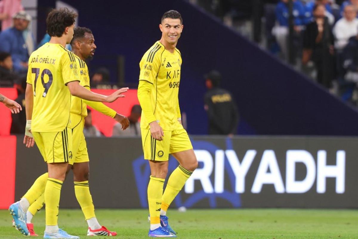 Nassr's Portuguese forward #07 Cristiano Ronaldo (R) celebrates with his teammates after scoring a goal during the Saudi Pro League football match between Al-Hilal and Al-Nassr at Kingdom Arena stadium in Riyadh on January 12, 2026. Fayez Nureldine / AFP