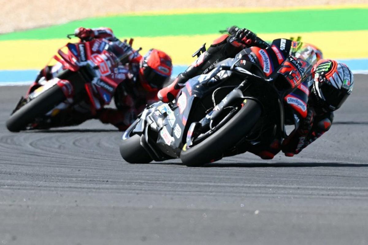 Aprilia Racing's Italian rider Marco Bezzecchi (R) and Ducati Lenovo's Spanish rider Marc Marquez compete during the MotoGP race of the Grand Prix of Brazil, at the Ayrton Senna International racetrack in Goiania, state of Goias, Brazil, on March 22, 2026. EVARISTO SA / AFP
