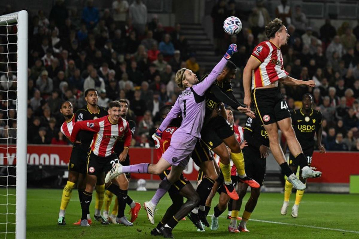 Brentford's Irish goalkeeper #01 Caoimhin Kelleher punches the ball clear during the English Premier League football match between Brentford and Chelsea at the Gtech Community Stadium in London on September 18, 2026. Glyn KIRK / AFP