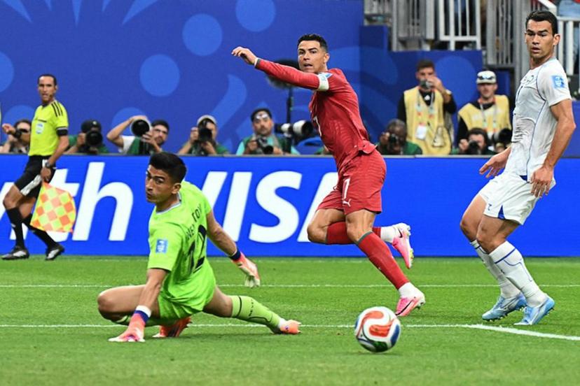 Portugal's forward #07 Cristiano Ronaldo (C) reacts as he scores his team's third goal during the 2026 World Cup Group K football match between Portugal and Uzbekistan at the Houston Stadium in Houston on June 23, 2026. Scotland and Brazil will meet in a 2026 World Cup Group C football match at the Miami Stadium in Miami Gardens on June 24, 2026. RONALDO SCHEMIDT / AFP