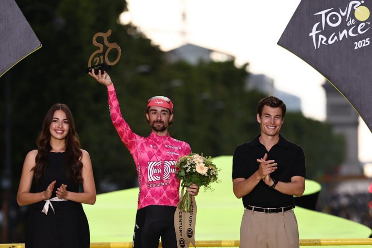 EF Education - EasyPost team's Irish rider Ben Healy celebrates on the podium with the most combative rider's award after the 21st and final stage of the 112th edition of the Tour de France cycling race, 132.3 km between Mantes-la-Ville and Paris Champs-Élysees, on July 27, 2025. Anne-Christine POUJOULAT / AFP