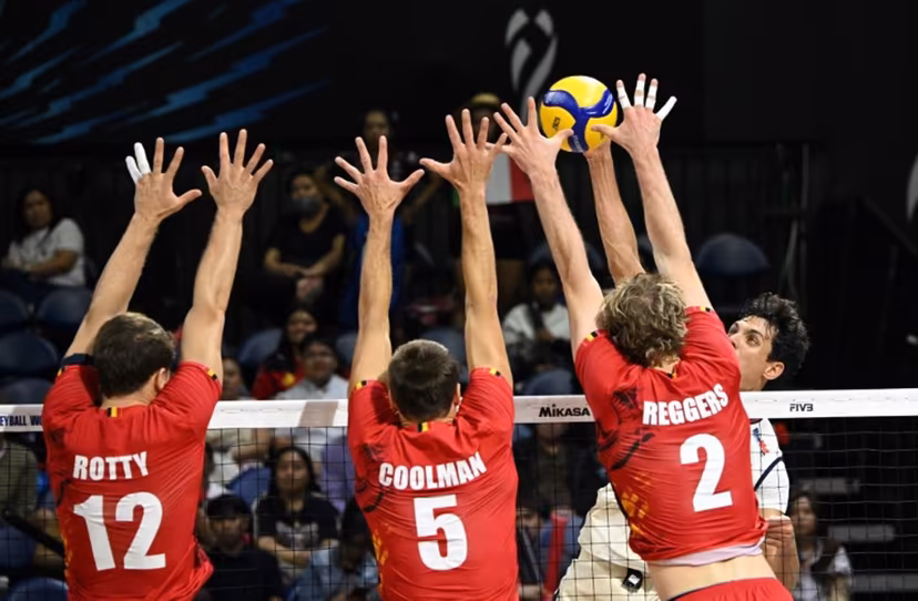 In this photo taken on April 16, 2025, Italy's Simone Anzani (R) spikes the ball against Belgium's Seppte Rotty (L), Pieter Coolman (C) and Ferre Reggers (R) at the World Men's Volleyball Championship in Manila. Ted ALJIBE / AFP