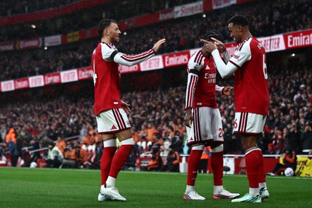 Arsenal's Brazilian defender #06 Gabriel Magalhaes (R) celebrates with Arsenal's English defender #04 Ben White (L) after scoring their second goal during the English Premier League football match between Arsenal and Everton at the Emirates Stadium in London on October 24, 2026. Henry Nicholls / AFP