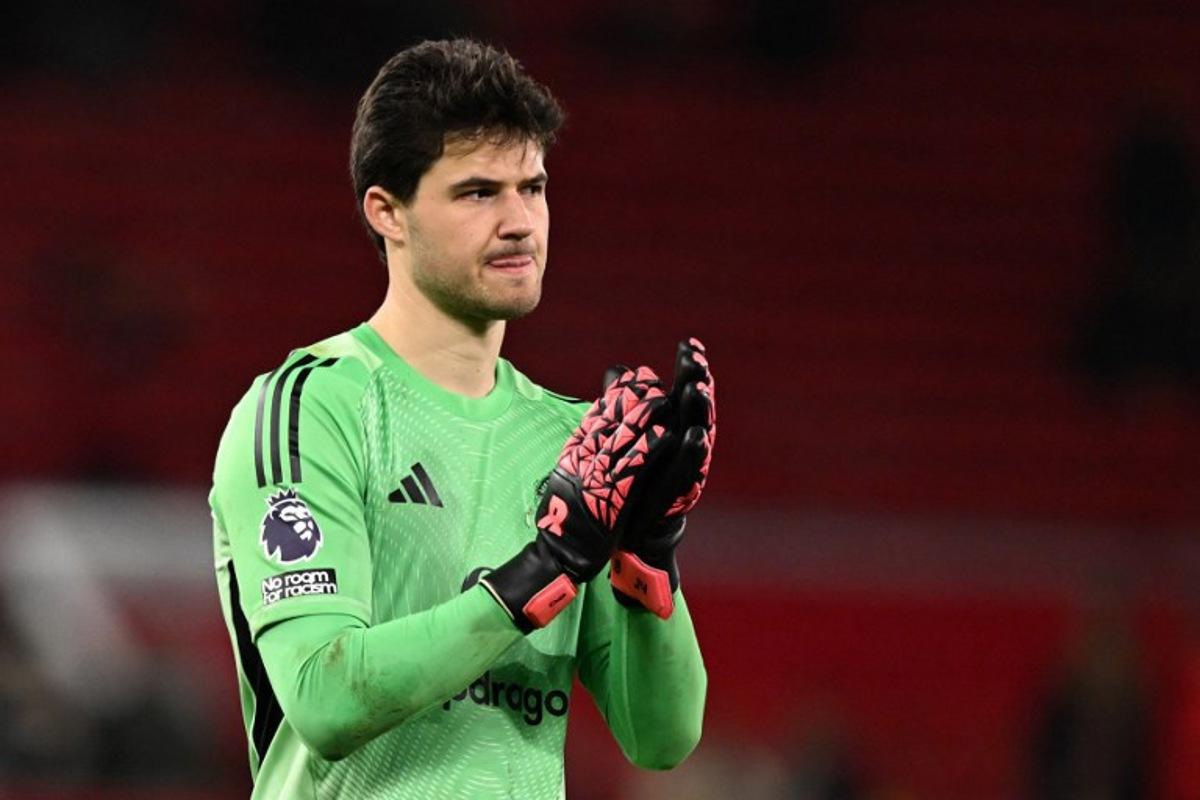Manchester United's Belgian goalkeeper #31 Senne Lammens applauds the crowd at the end of the English Premier League football match between Manchester United and Bournemouth at Old Trafford in Manchester, north west England, on December 15, 2025. PETER POWELL / AFP