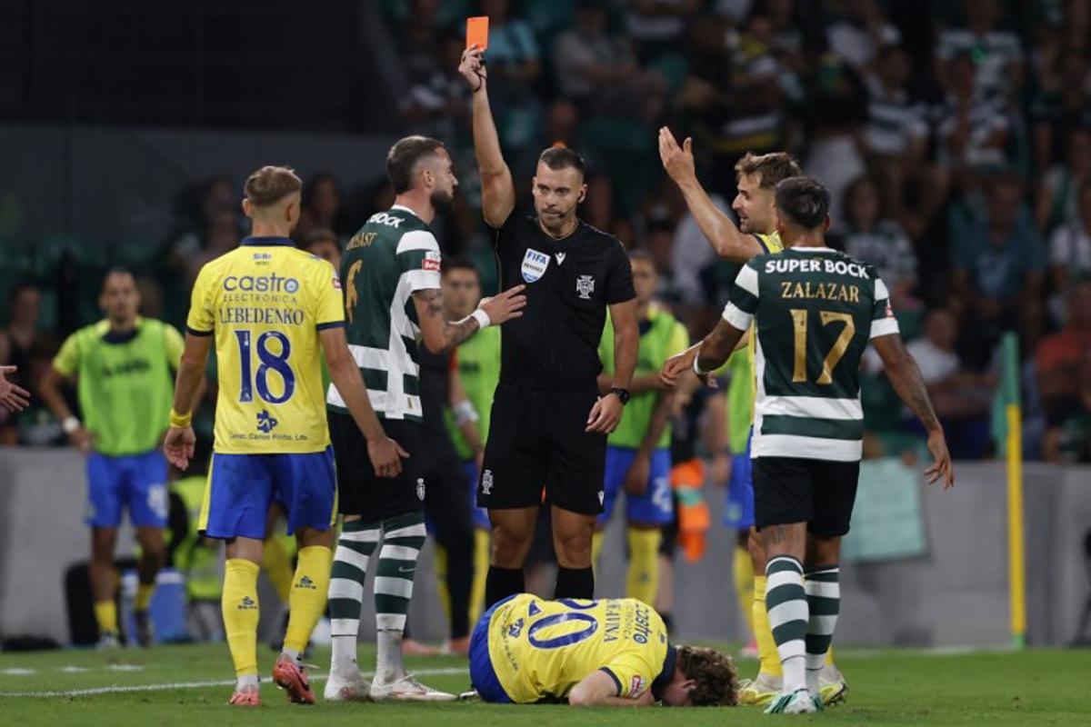 Sporting Lisbon's Belgian defender #06 Zeno Debast (2nd L) receives a red card during the Portuguese League football match between Sporting CP and FC Arouca at the Jose Alvalade stadium in Lisbon on September 19, 2026. FILIPE AMORIM / AFP