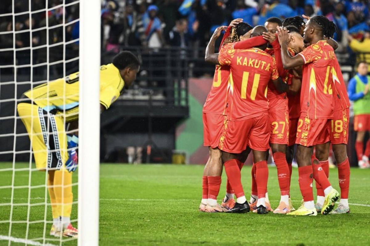 Democratic Republic Of Congo's midfielder #11 Mario Stroeykens is congratulated by teammates after scoring a goal during the Africa Cup of Nations (CAN) Group D football match between Botswana and Democratic Republic of Congo at El Madina Stadium in Rabat on December 30, 2025. SEBASTIEN BOZON / AFP