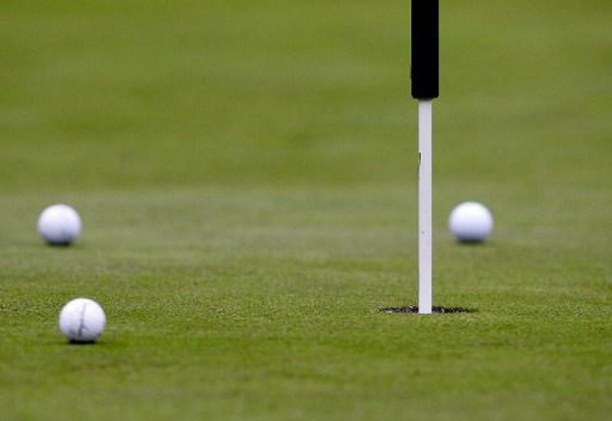 The three balls from the leaderball lies on the first green after the second shoot during the third day of play at the PGA European Tour, Scandinavian Masters in Kungsangen outside Stockholm, 30 July 2005. Of the three in the ball, Barry Lane of England and Bradley Dredge of Wales stayed in the top on -18 while Sweden's Pierre Fulke dropped to a sixth place on -13. AFP PHOTO - SVEN NACKSTRAND