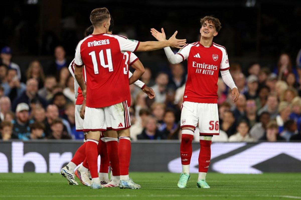 Arsenal's English midfielder #56 Max Dowman (R) celebrates scoring the team's third goal during the League Cup third Round football match between Ipswich Town and Arsenal at Portman Road in Ipswich, eastern England on September 15, 2026. Adrian Dennis / AFP