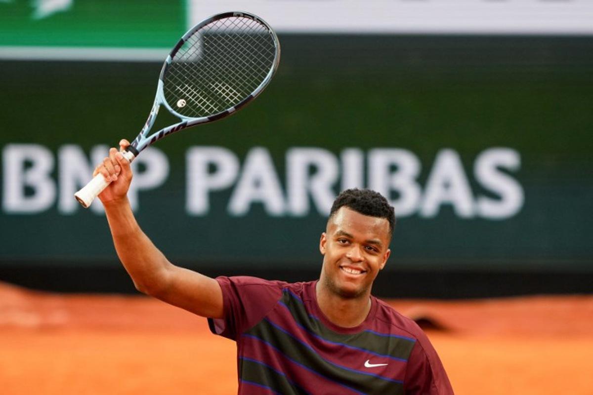 France's Giovanni Mpetshi Perricard celebrates after winning his men's singles match against Belgium's Zizou Bergs on day 1 of the French Open tennis tournament on Court Suzanne-Lenglen at the Roland-Garros Complex in Paris on May 25, 2025. Dimitar DILKOFF / AFP