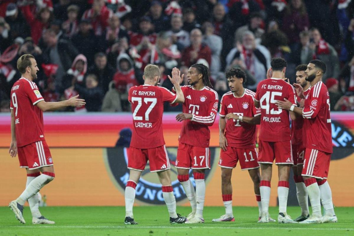 Bayern Munich's French midfielder #17 Michael Olise (3rd L) celebrates scoring the 3-0 goal with his teammates during the German first division Bundesliga football match between FC Bayern Munich and RB Leipzig in Munich, southern Germany, on October 17, 2026. Alexandra BEIER / AFP