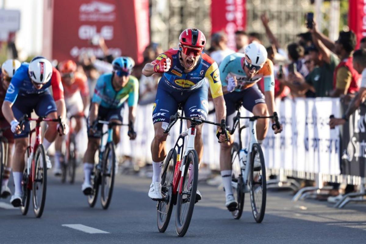 Lidl-Trek's Italian rider Jonathan Milan reacts after crossing the finish line first during the fourth stage of the UAE Tour cycling event in al-Fujairah on February 19, 2026. Fadel SENNA / AFP