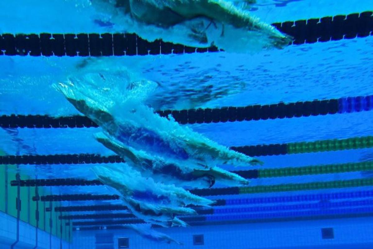 Swimmers are seen through an underwater window as they compete in a heat for the Women¿s 1500m Freestyle Swimming event during the LEN European Aquatics Championships at the Duna Arena in Budapest on May 20, 2021. Tobias SCHWARZ / AFP
