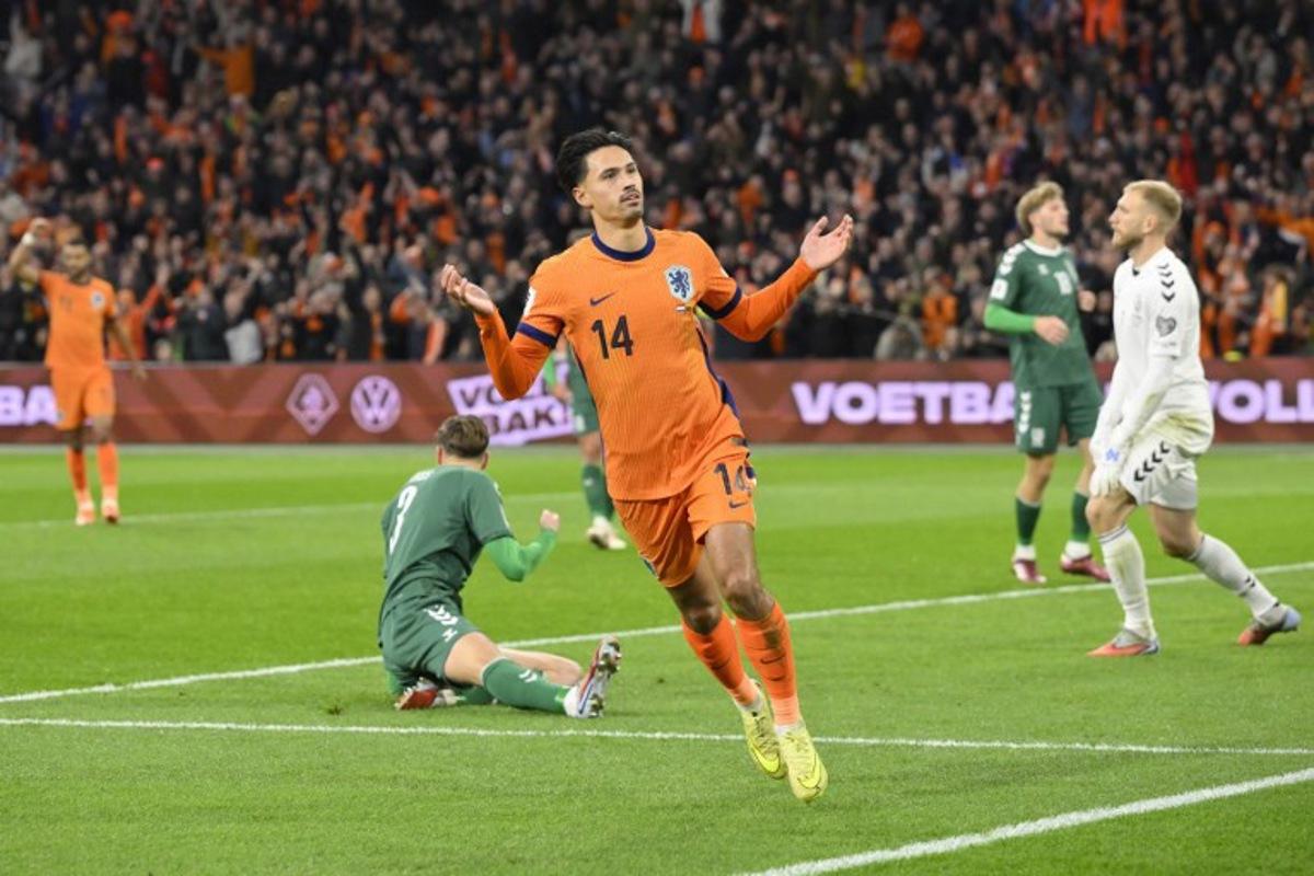 Netherlands' midfielder #14 Tijjani Reijnders (C) celebrates after scoring the Netherlands first goal during the FIFA World Cup 2026 Group G European qualification football match between the Netherlands and Lithuania at the Johan Cruijff Arena, in Amsterdam, on November 17, 2025. JOHN THYS / AFP