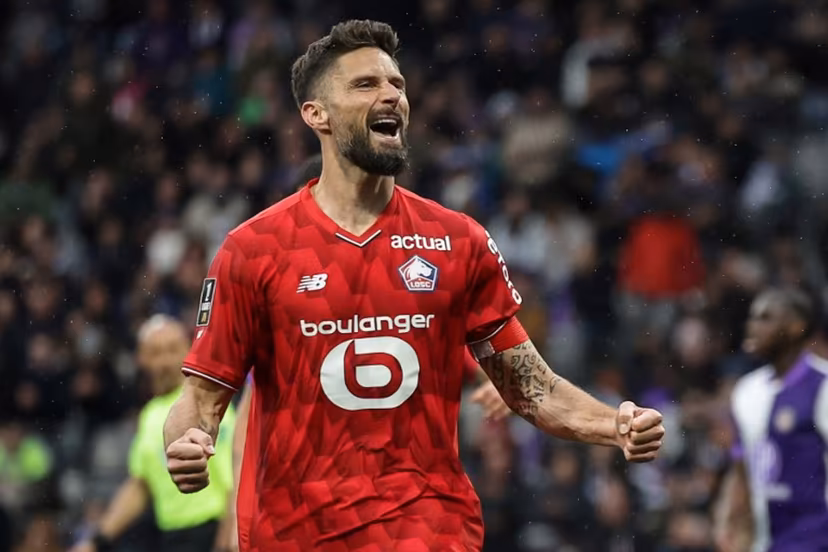 Lille's French forward #09 Olivier Giroud celebrates after scoring during the French L1 football match between Toulouse FC and Lille LOSC at the TFC Stadium in Toulouse, southwestern France, on April 12, 2026. Valentine CHAPUIS / AFP