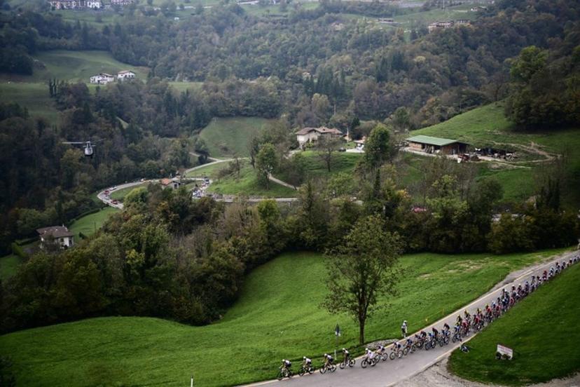 The pack of riders (peloton) cycles in the Zambla Alta ascent during the 119th edition of the Giro di Lombardia (Tour of Lombardy), a 238km cycling race from Como to Bergamo on October 11, 2025. Marco BERTORELLO / AFP
