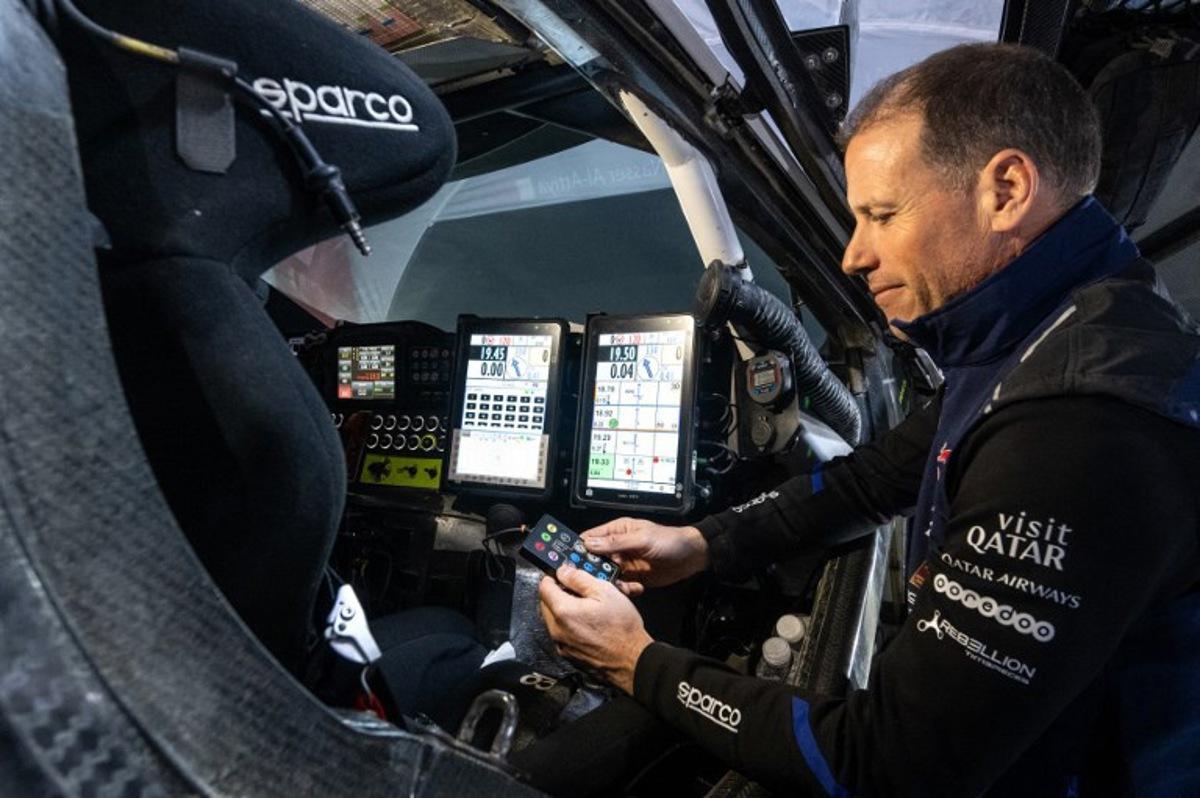 French co-driver Mathieu Baumel checks the navigation instruments in Nasser Racing's Qatari driver Nasser Al-Attiyah's car after Stage 5 of the Dakar Rally 2024, between Al Hofuf and Shubaytah, Saudi Arabia, on January 10, 2024. PATRICK HERTZOG / AFP