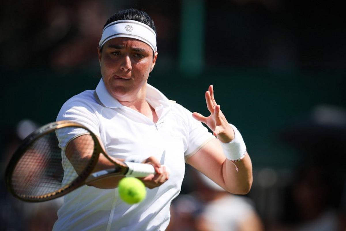 Tunisia's Ons Jabeur plays a forehand return to Bulgaria's Viktoriya Tomova during their women's singles first round tennis match on the first day of the 2025 Wimbledon Championships at The All England Lawn Tennis and Croquet Club in Wimbledon, southwest London, on June 30, 2025. HENRY NICHOLLS / AFP
