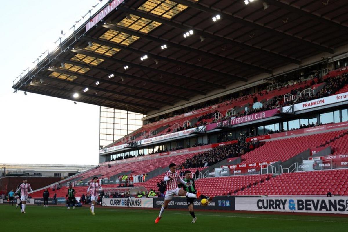 Players compete for the ball against a view of empty seats during the English FA Cup third round football match between Stoke City and Brighton and Hove Albion at the bet365 Stadium, in Stoke on Trent, central England, on January 6, 2024. Darren Staples / AFP
