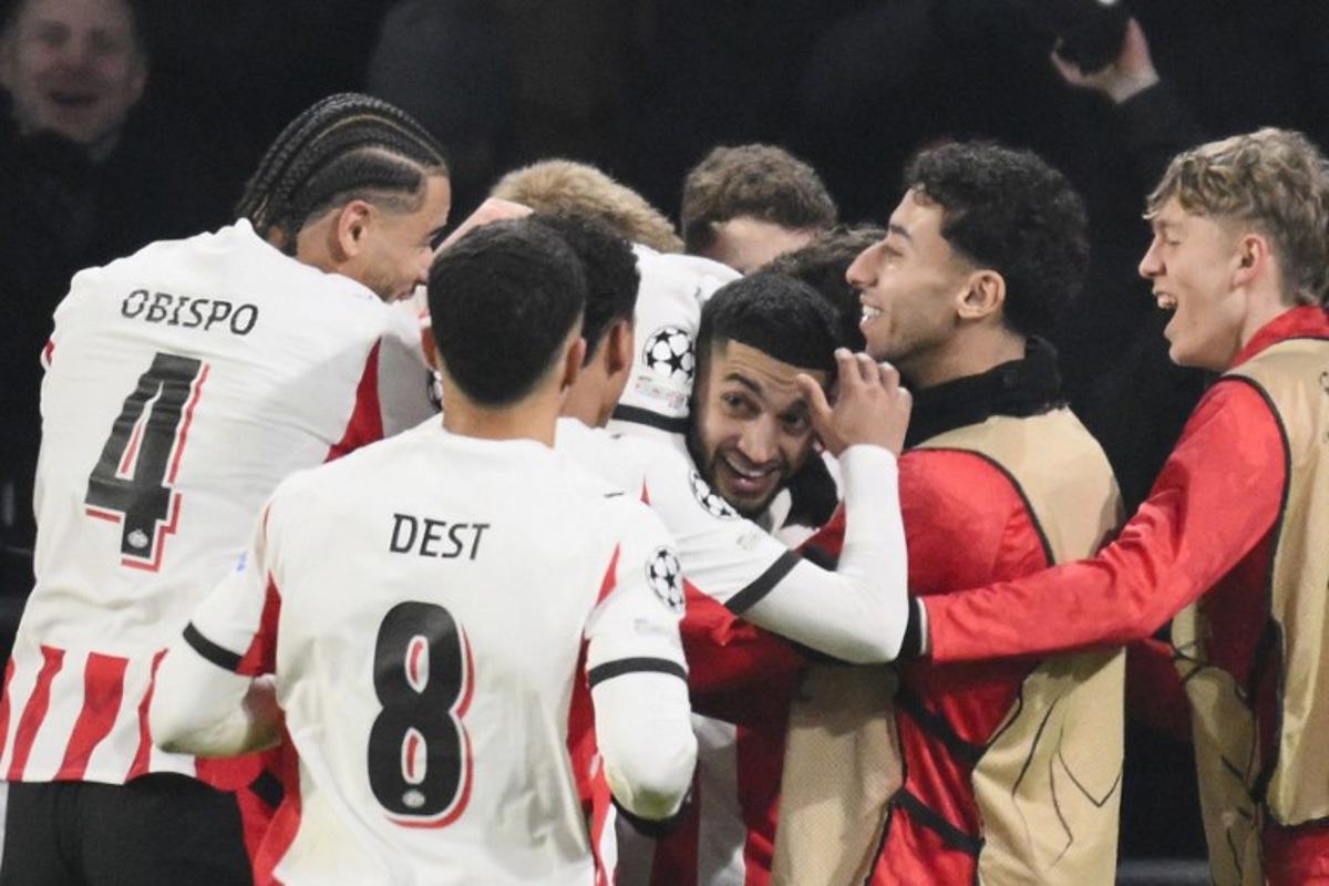 PSV Eindhoven's Moroccan midfielder #34 Ismael Saibari (3R) celebrates with teammates after scoring his team's first goal during the UEFA Champions League league phase day 8 football match between PSV Eindhoven and Bayern Munich at Philips Stadion in Eindhoven on January 28, 2026. JOHN THYS / AFP