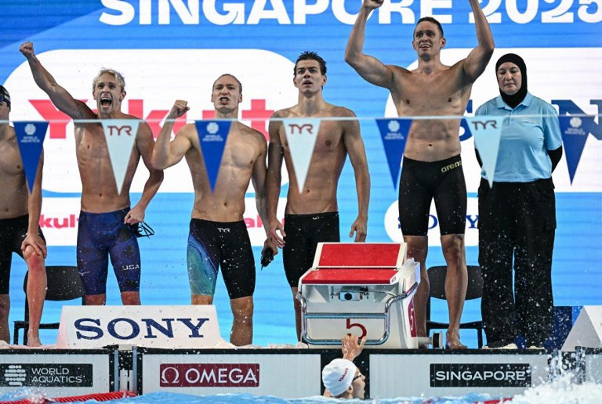 Neutral Athlete's team Neutral Athlete swimmer Andrei Minakov, Neutral Athlete swimmer Miron Lifintsev, Neutral Athlete swimmer Kirill Prigoda and Neutral Athlete swimmer Egor Kornev react after winning the men's 4x100m medley relay swimming event during the 2025 World Aquatics Championships in Singapore on August 3, 2025. Manan VATSYAYANA / AFP