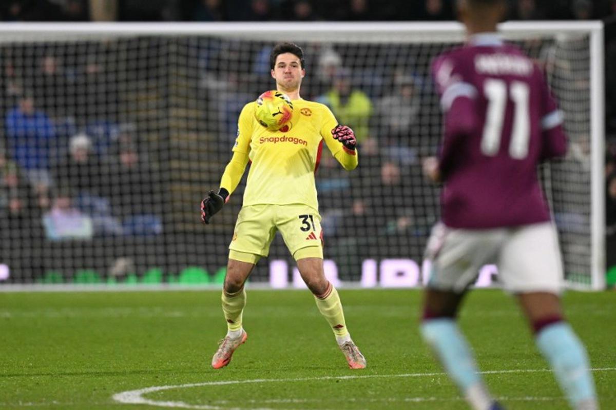 Manchester United's Belgian goalkeeper #31 Senne Lammens controls the ball on his chest near the half-way line during the English Premier League football match between Burnley and Manchester United at Turf Moor in Burnley, north-west England on January 7, 2026. Oli SCARFF / AFP