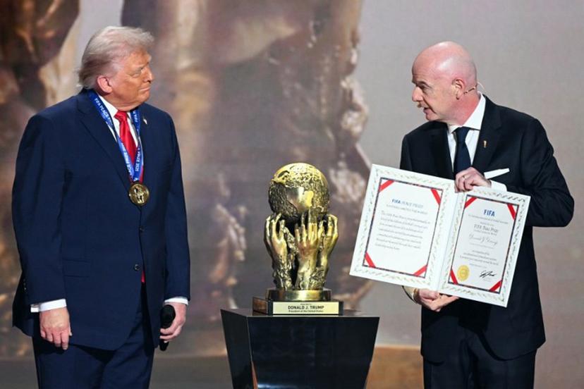 (L-R) US President Donald Trump receives the FIFA Peace Prize from Italian Fifa President Gianni Infantino during the draw for the 2026 FIFA Football World Cup taking place in the US, Canada and Mexico, at the Kennedy Center, in Washington, DC, on December 5, 2025. Jim WATSON / AFP