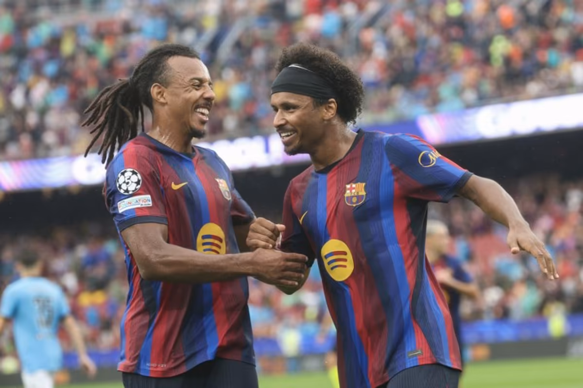 Barcelona's German forward #14 Karim Adeyemi (R) celebrates scoring his team's second goal with teammate Barcelona's French defender #23 Jules Kounde during the UEFA Champions League first round day 1 football match between FC Barcelona and Feyenoord at Camp Nou stadium in Barcelona on September 9, 2026. Lluis GENE / AFP