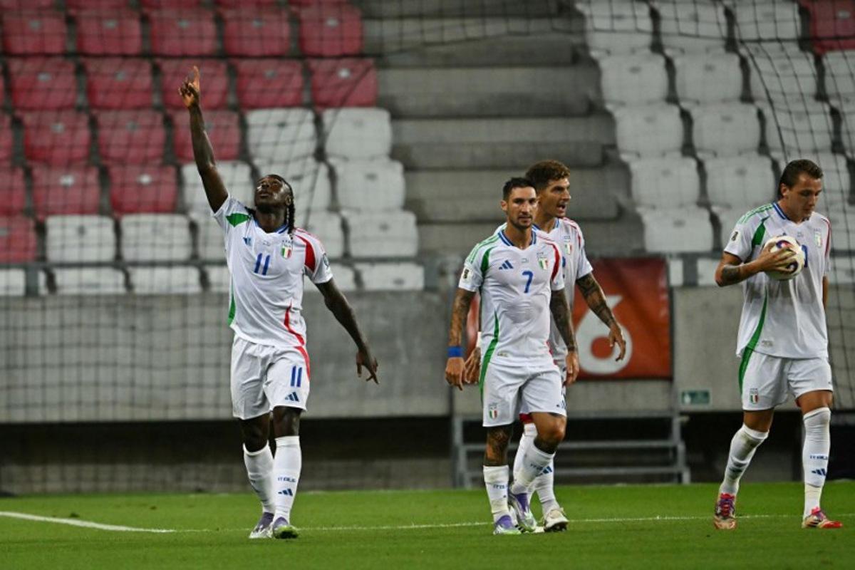 Italy's forward #11 Moise Kean (L) celebrates after scoring the equalizing 1-1 goal during the 2026 World Cup qualifiers Europe zone group I football match between Israel and Italy on September 8, 2025 in Debrecen, Hungary. Attila KISBENEDEK / AFP