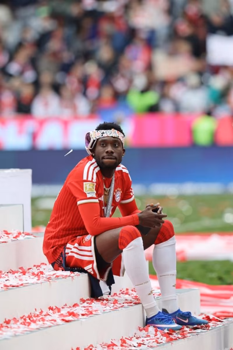 Bayern Munich's Canadian defender #19 Alphonso Davies sits on the stairs during celebrations for the Bundesliga trophy after wining the German first division Bundesliga football match between FC Bayern Munich and FC Cologne in Munich, southern Germany, on May 16, 2026. Alexandra BEIER / AFP