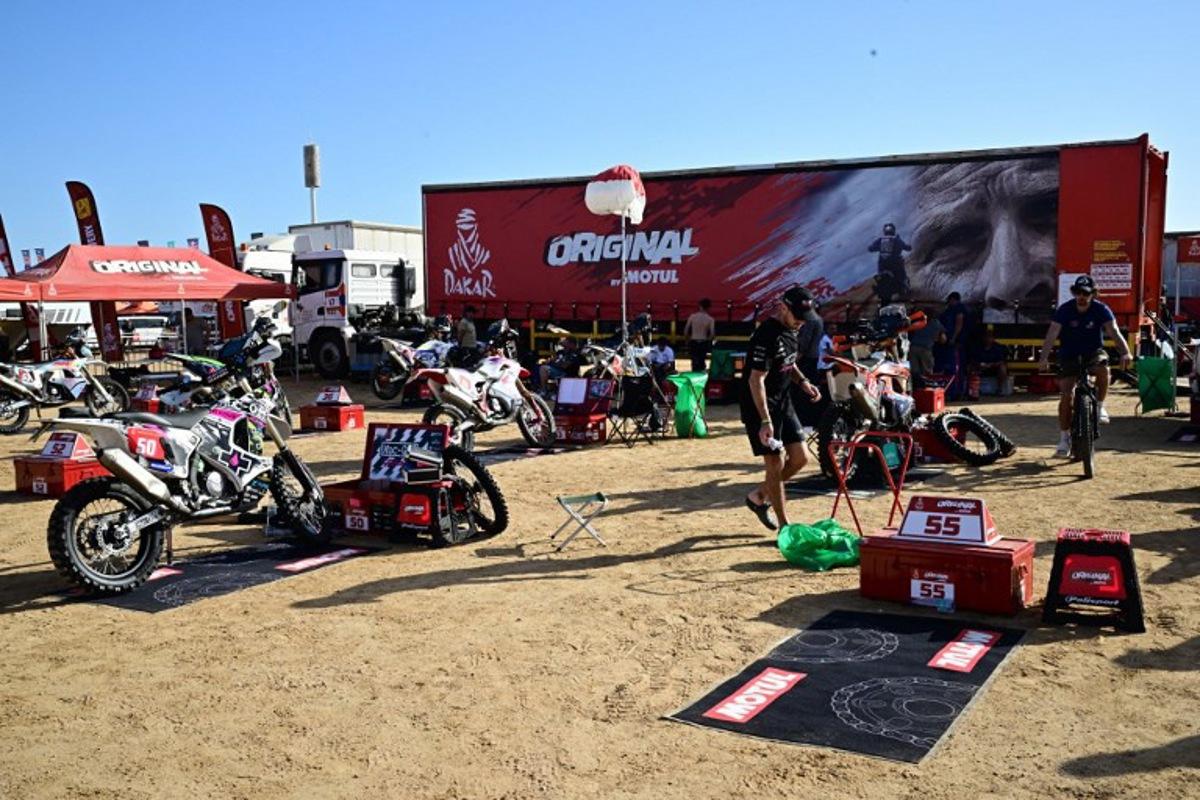 Some of the competitors of the Dakar Rally 2026 prepare their motorbikes at a temporary camp in Yanbu, Saudi Arabia, on January 2, 2026. The 48th edition of the Dakar Rally is set to start the prologue in Yanbu on January 3, 2026. Giuseppe CACACE / AFP