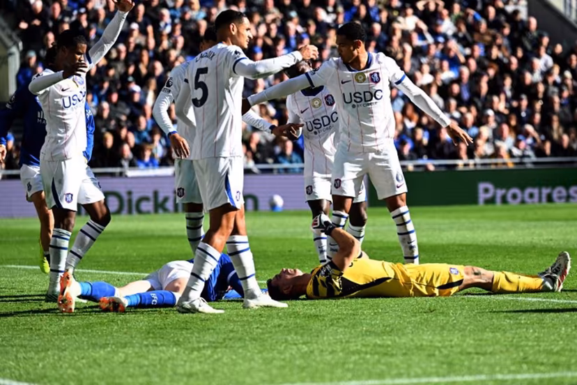 Chelsea's Argentinian goalkeeper #26 Emiliano Martinez and Everton's English defender #04 Jarrad Branthwaite lie injured after a clash during the English Premier League football match between Everton and Chelsea at Hill Dickinson Stadium in Liverpool, north west England on October 17, 2026. PETER POWELL / AFP
