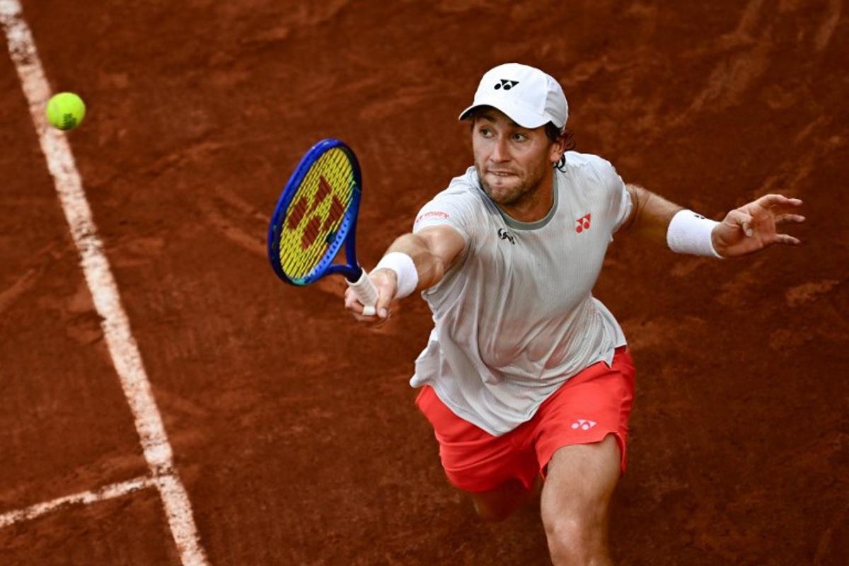 Norway's Casper Ruud plays a backhand return to US Tommy Paul during their men's singles match on day 6 of the French Open tennis tournament on Court Suzanne-Lenglen at the Roland-Garros Complex in Paris on May 29, 2026. JULIEN DE ROSA / AFP