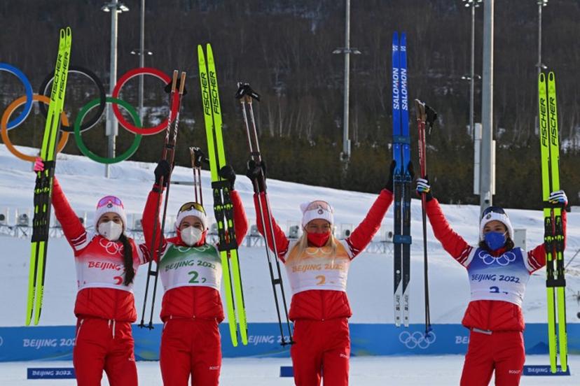 (From L) Russia's Yulia Stupak, Russia's Natalia Nepryaeva, Russia's Tatiana Sorina and Russia's Veronika Stepanova celebrate on the podium after Russia won Gold in the women's Cross Country 4x5km relay event during the Beijing 2022 Winter Olympic Games on February 12, 2022, at the Zhangjiakou National Cross-Country Skiing Centre. Pierre-Philippe MARCOU / AFP