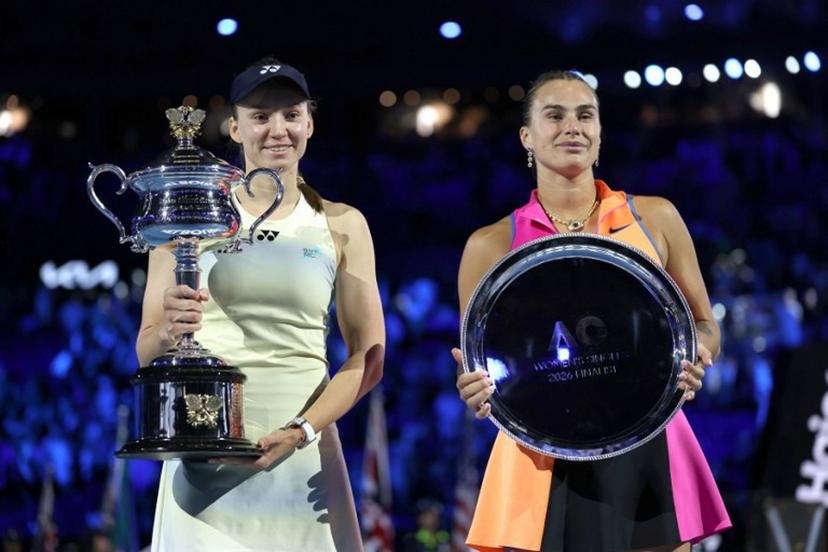 Kazakhstan's Elena Rybakina (L), the women's singles champion, and runner-up Aryna Sabalenka of Belarus pose for photos on the podium after the Australian Open women's final on Day 14 of the tennis tournament in Melbourne on January 31, 2026. Martin KEEP / AFP