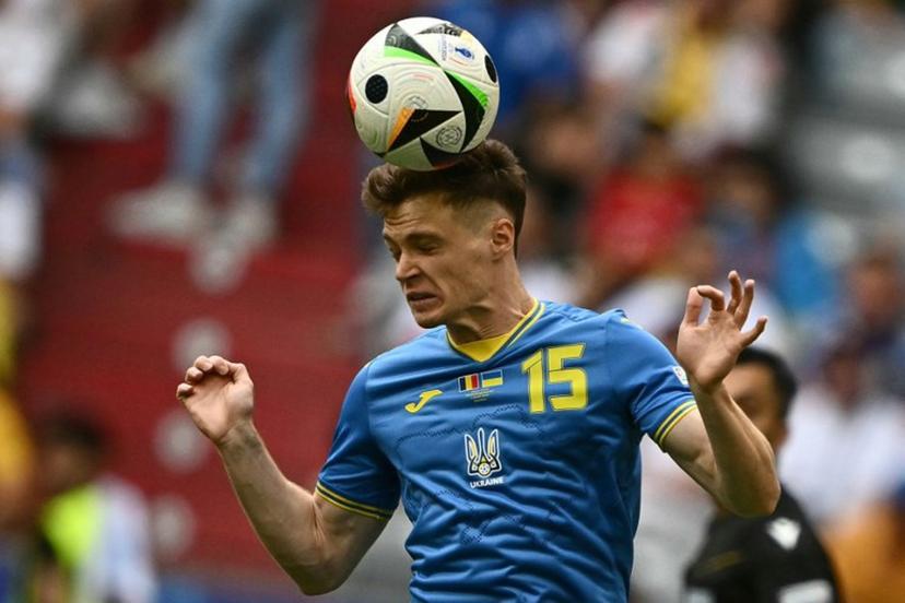 Ukraine's midfielder #15 Viktor Tsygankov heads the ball during the UEFA Euro 2024 Group E football match between Romania and Ukraine at the Munich Football Arena in Munich on June 17, 2024. Fabrice COFFRINI / AFP