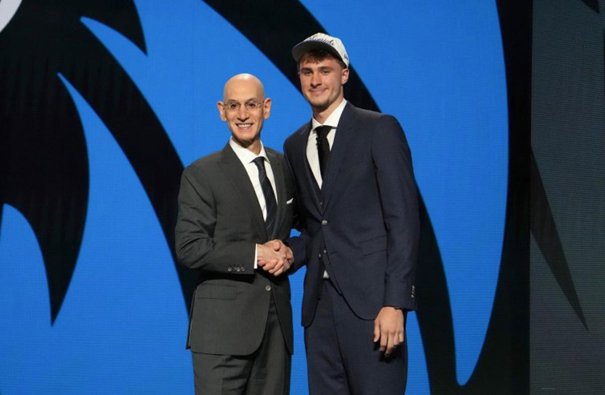 US basketball player Cooper Flagg (R) shakes hands with NBA Commissioner Adam Silver after being selected first overall by the Dallas Mavericks during the opening round of the 2025 NBA Draft at Barclays Center in Brooklyn, New York, on June 25, 2025. Versatile US college teen star Cooper Flagg was selected first overall in the NBA draft on June 25 by the Dallas Mavericks, where he'll join a star-laden team already touted as a playoff threat next season. Flagg, a consensus pick as the top US college player as a freshman at Duke University last season, is the second-youngest player taken first overall. TIMOTHY A. CLARY / AFP