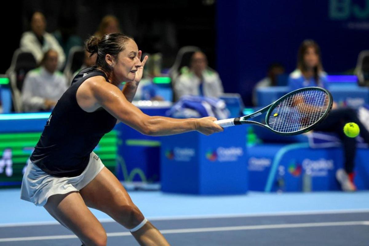 Italy's Elisabetta Cocciaretto hits a return to Ukraine's Marta Kostyuk during their first singles semi-final match between Italy and Ukraine at the Billie Jean King Cup in Shenzhen, southern China's Guangdong province on September 19, 2025. STR / AFP