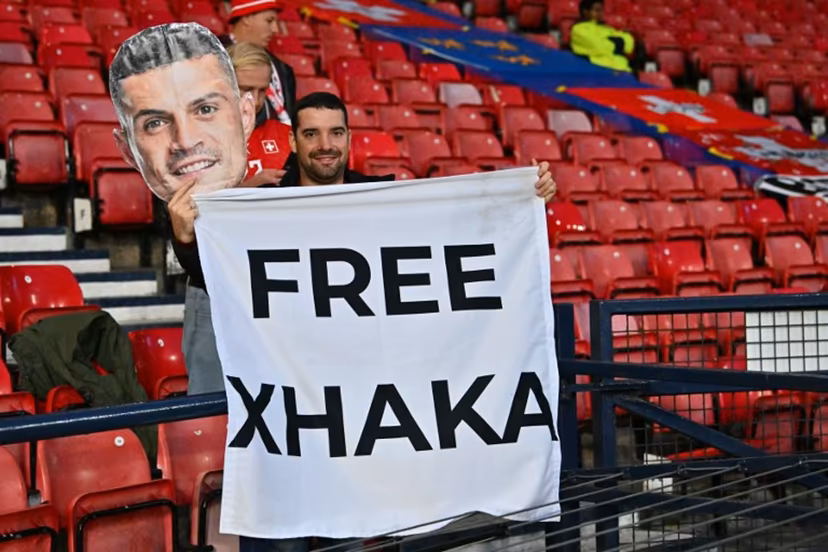 A fan of Switzerland's midfielder Granit Xhaka hlds up a banner in the crowd ahead of the UEFA Nations League, League B, Group 1 match football match between Scotland and Switzerland at Hampden Park in Glasgow, Scotland on September 29, 2026. ANDY BUCHANAN / AFP