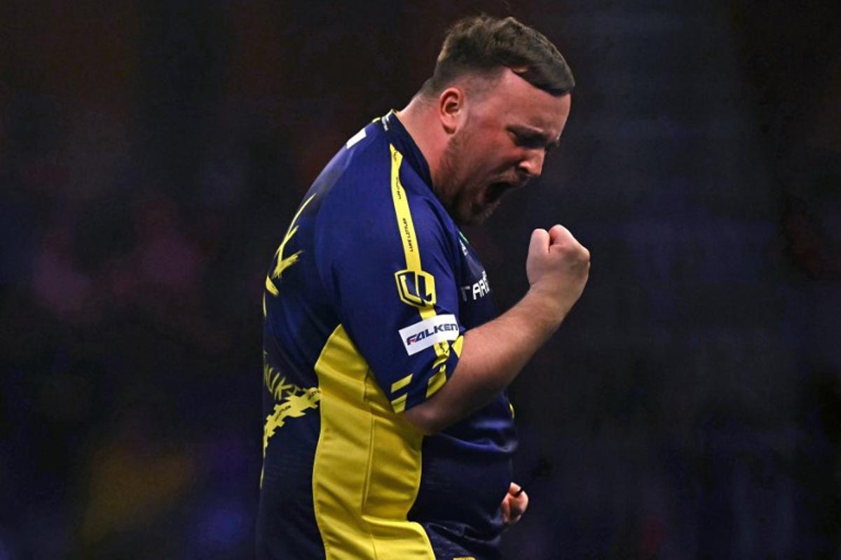 England's Luke Littler celebrates winning the fourth set against Netherlands' Michael van Gerwen during the PDC World Darts Championship final, at Alexandra Palace in London on January 3, 2025. Ben STANSALL / AFP