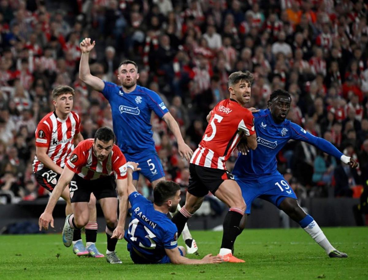 Athletic Bilbao's Spanish defender #05 Yerai Alvarez and Rangers' French defender #19 Clinton Nsiala eye the ball during the UEFA Europa League quarter final second leg football match between Athletic Club Bilbao and Glasgow Rangers, at the San Mames stadium in Bilbao on April 17, 2025. ANDER GILLENEA / AFP