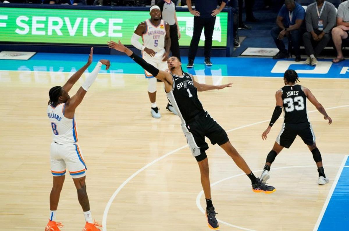 San Antonio Spurs French center #01 Victor Wembanyama reaches to block a shot by Oklahoma City Thunder's US forward #08 Jalen Williams during the NBA pre-season basketball game between San Antonio Spurs and Oklahoma City Thunder at Paycom Center arena in Oklahoma City, Oklahoma, on October 9, 2023. TIMOTHY A. CLARY / AFP