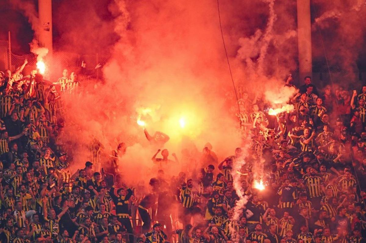 Fenerbahce's fans light smoke flares during the Turkish Super lig football match between Fenerbahce and Galatasaray at the Rams Park stadium in Istanbul, on April 26, 2026. Yasin AKGUL / AFP