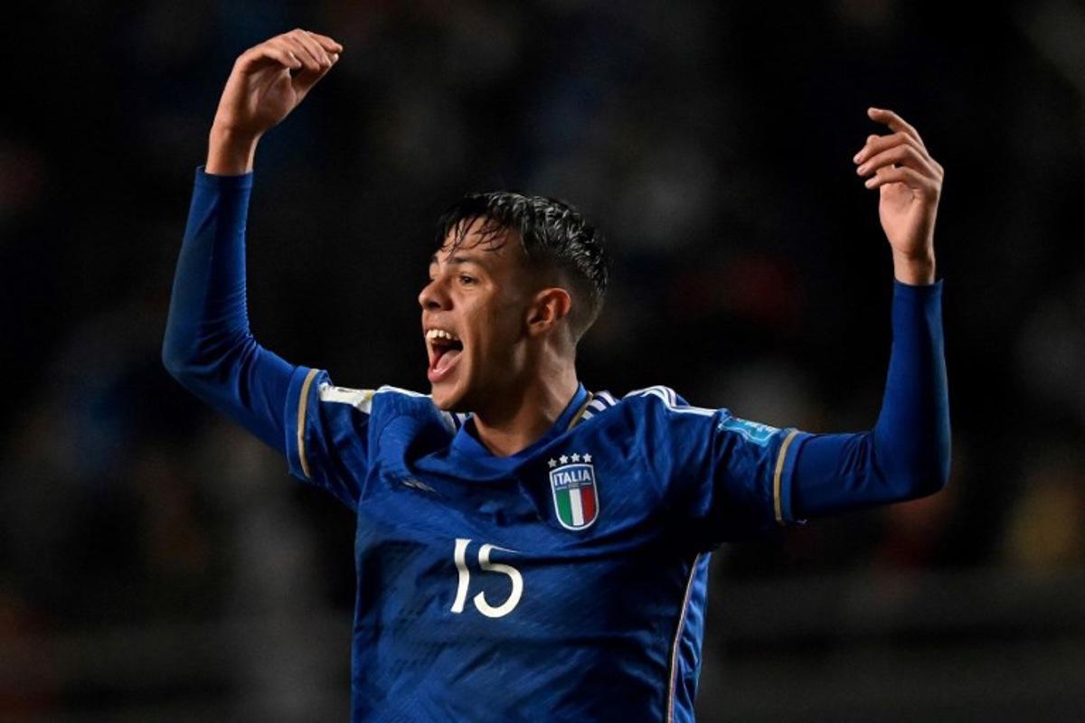 Italy's defender Alessandro Fontanarosa celebrates a goal scored by midfielder Cesare Casadei during the Argentina 2023 U-20 World Cup round of 16 football match between England and Italy at the Diego Armando Maradona stadium in La Plata, Argentina, on May 31, 2023. LUIS ROBAYO / AFP
