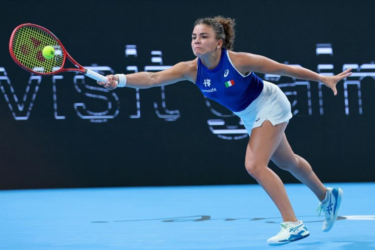 Italy's Jasmine Paolini hits a return to China's Zheng Qinwen during their women's singles quarter-final match at the Billie Jean King Cup tennis tournament in Shenzhen, southern China's Guangdong province on September 24, 2026. CN-STR / AFP